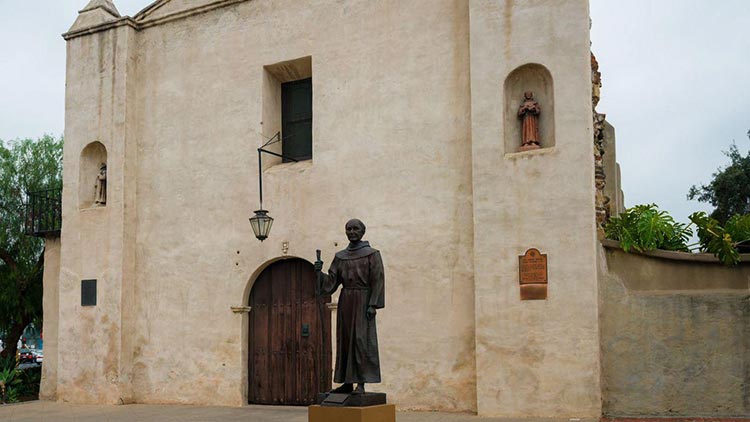 San Gabriel Mission's front facade with historic bell tower and arched entrance.