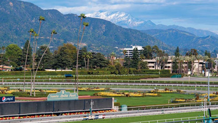 Santa Anita Park horse race track with scenic mountain views on a sunny day.