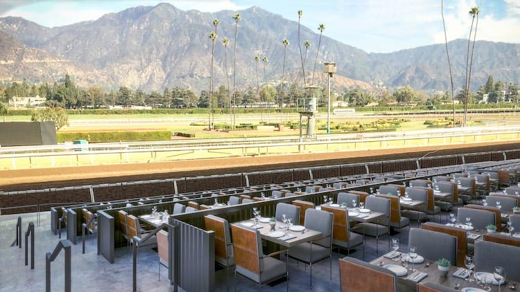 Panoramic view of Santa Anita Park's horse race track with mountains in the background